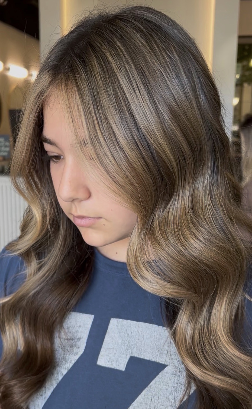 Dimensional brunette with a soft face frame by Aaliyah at AMAVI Salon