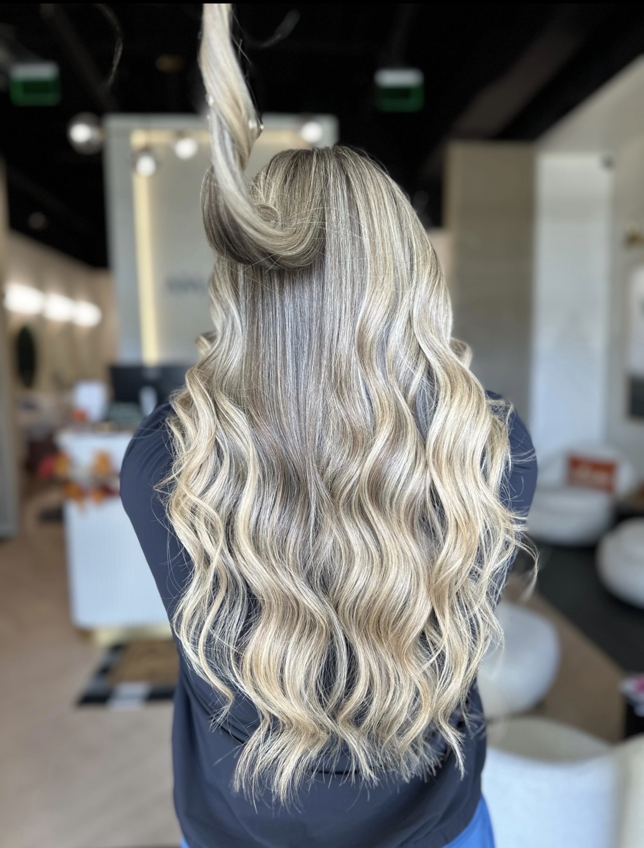 Bright dimensional blonde and waves by Ana at AMAVI Salon