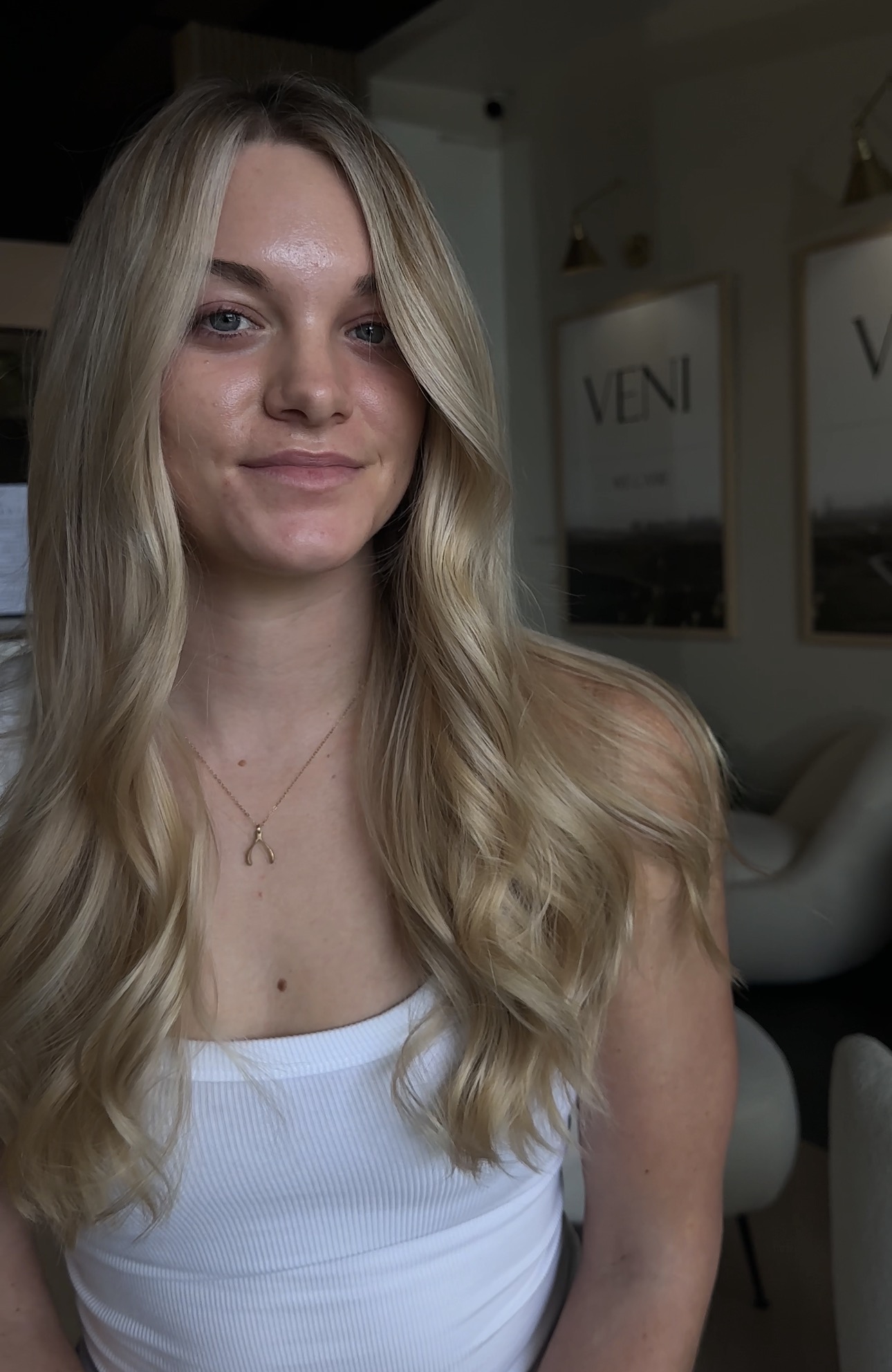 Lived-in blonde with a bright face frame by Ariella at AMAVI Salon