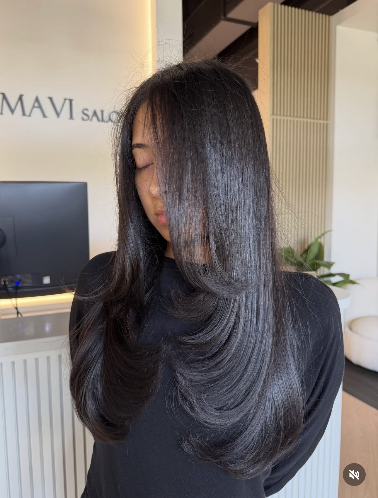 Glossy dark brunette with cascading layers by Monica at AMAVI Salon